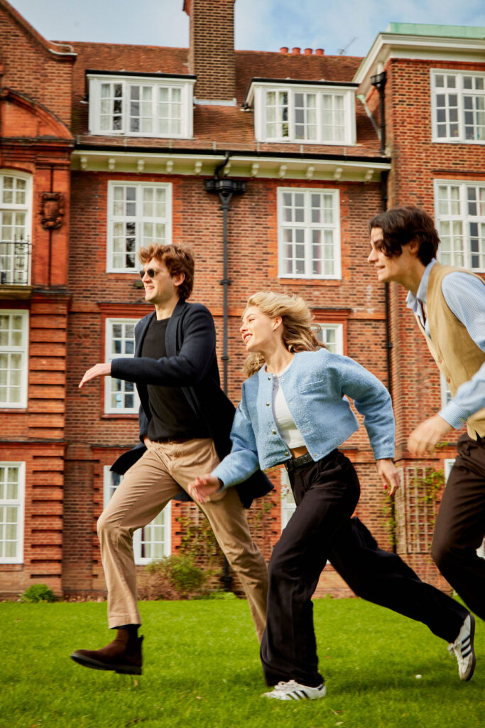 Regents University London: A group of students enjoying a sunny day and running around the university