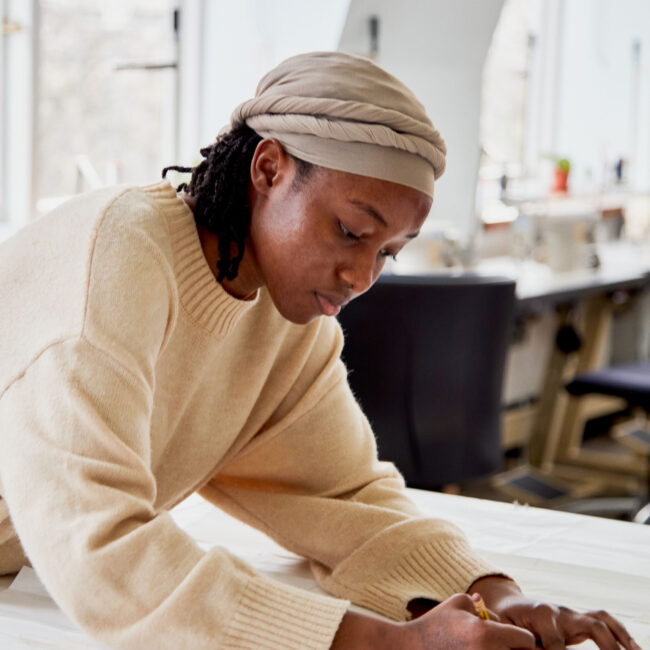 Fashion design student sketching her project at Regents University London