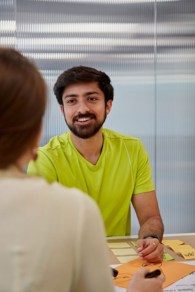 Two students having a conversation during a hackathon at Regent's University in London