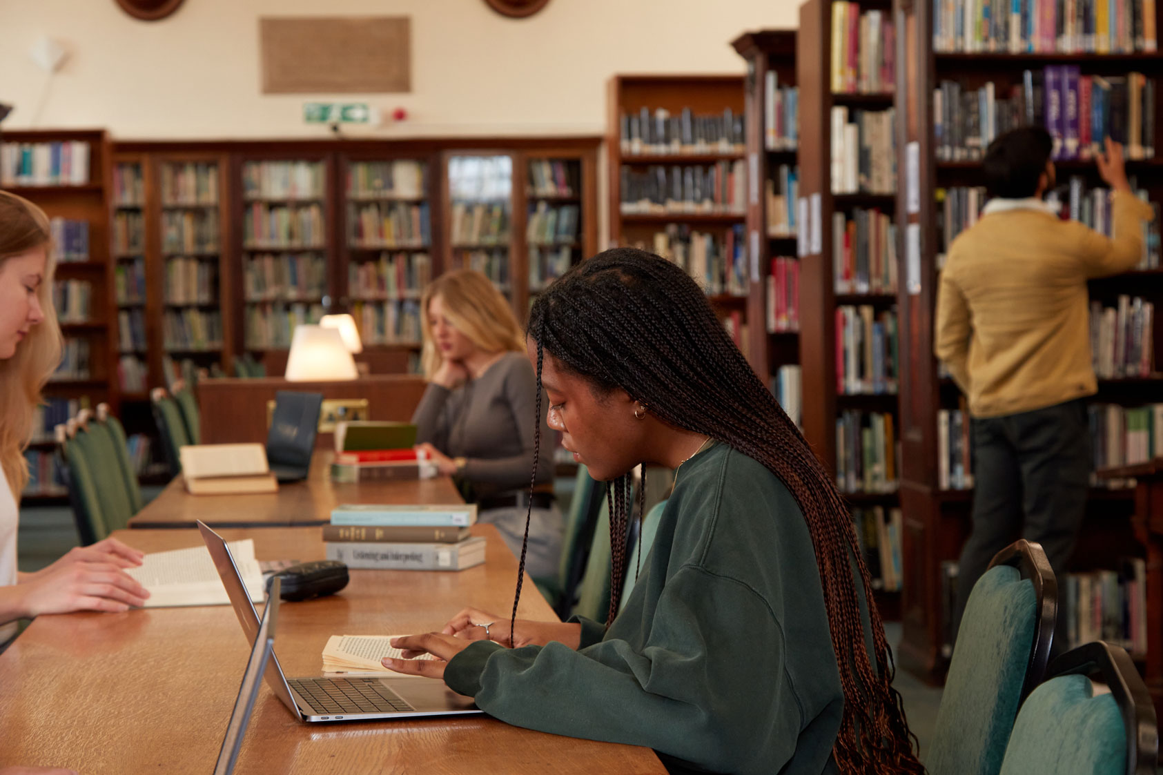 Regents University London students focused on their studies in the library