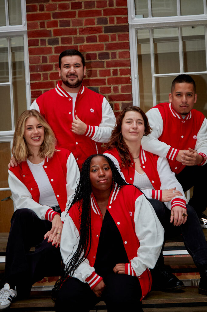 Showcasing their pride: Regents University London students united in their vest jackets outside the university